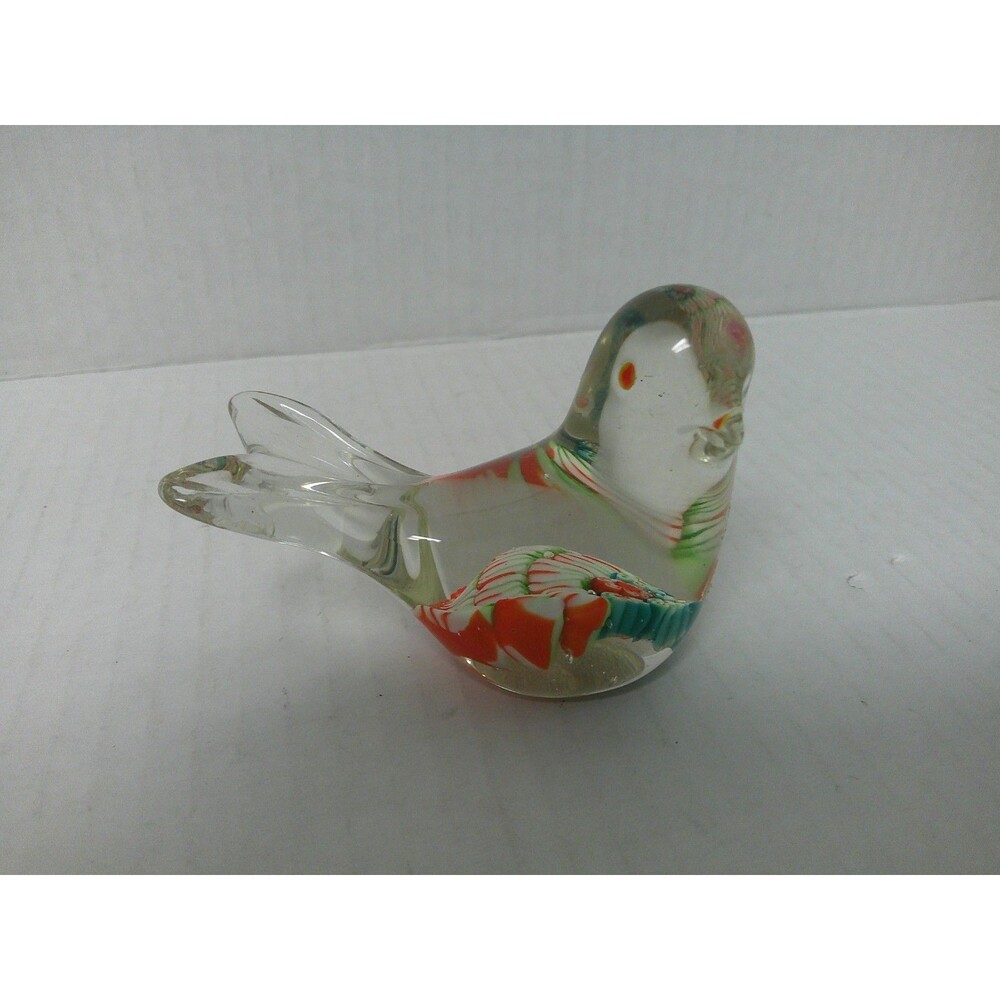 CLEAR GLASS BIRD PAPER WEIGHT WITH ORANGE EYES AND COLORFUL FEATHERS. SO CUTE